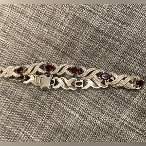 Sterling silver and Ruby bracelet. 7 3/4” Double security class. Beautiful.